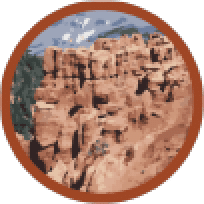 Southeast Region of Morgan Valley. An illustrated badge depicting a detailed rocky canyon with shades of brown and orange, showcasing the rugged texture of the canyon walls with shadows that highlight depth and crevices. The sky is a light blue with white clouds, and the badge has a reddish-brown border. The image is reminiscent of canyon landscapes such as those found in the American Southwest.