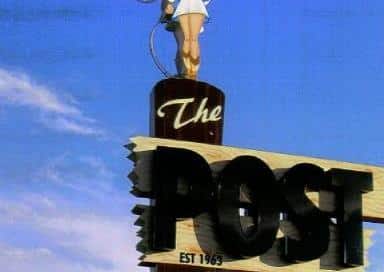 The Post #13 roadside sign with a cowgirl at the top.